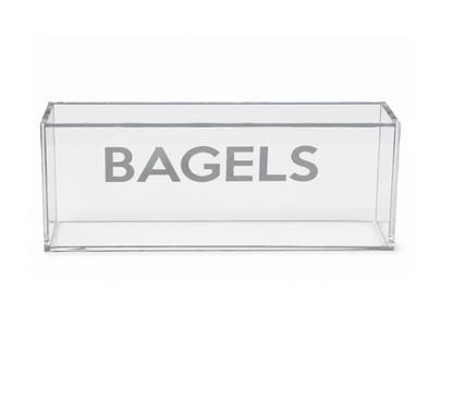 Introducing the Eye Candy Bagel Tray—a clear, rectangular acrylic box featuring the word “BAGELS” in bold gray lettering across the front. This food-safe tray, shown empty against a plain white background, is ideal for gifting or adding a touch of style to your countertop organization.