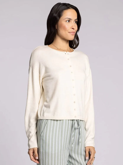Woman wearing ivory cropped knit cardigan sweater with button front and relaxed fit
