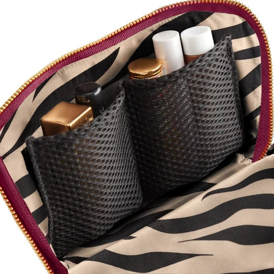 Wine/Zebra, Makeup bag with zebra pattern containing cosmetic items.