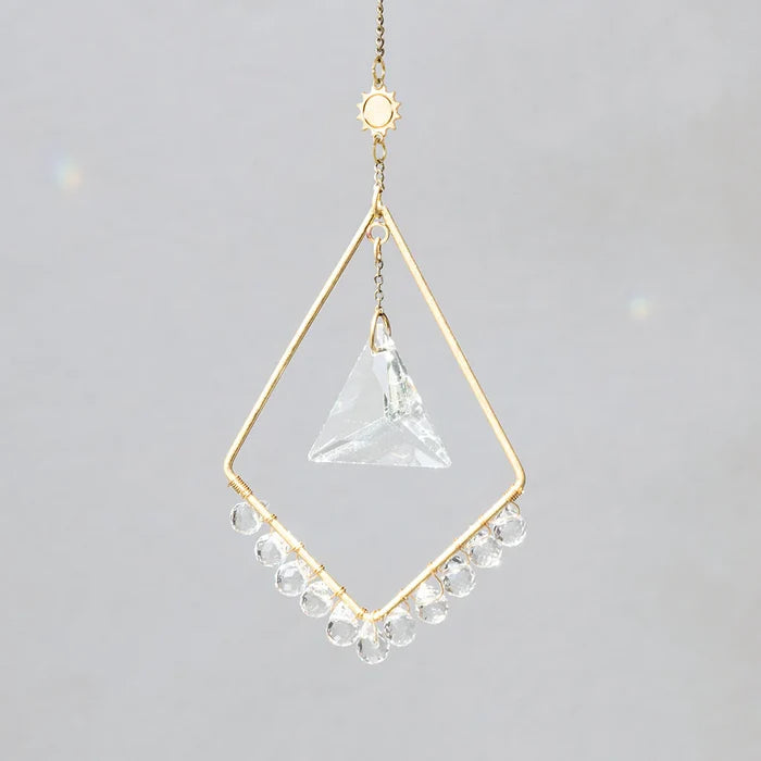 Scout Curated Wears Sun Harmony mini crystal suncatcher featuring gold-plated brass frame and crystal prism creating rainbow reflections
