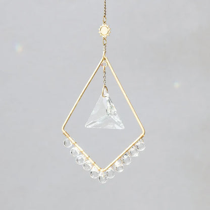 Scout Curated Wears Sun Harmony mini crystal suncatcher featuring gold-plated brass frame and crystal prism creating rainbow reflections