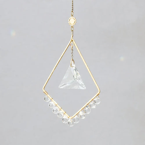 Scout Curated Wears Sun Harmony mini crystal suncatcher featuring gold-plated brass frame and crystal prism creating rainbow reflections