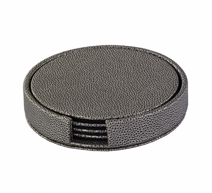 The Bodrum Skate Coaster Set of 4 includes round, textured dark gray phthalate-free vinyl coasters with a holder featuring a front opening that reveals the matching set inside.