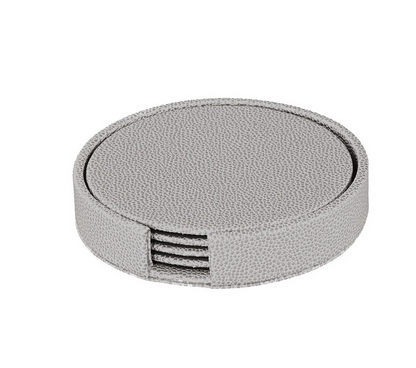 The Bodrum Skate Coaster Set of 4 features phthalate-free vinyl coasters in a round, light gray textured holder with an open slot in front to display the stacked coasters inside.