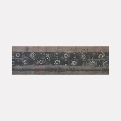 The artwork 'Vault Lights (Treads & Risers-1)' by Cora Jane Glasser features horizontal bands of weathered gray and muted brown tones with circular patterns resembling aged vault lights. Created in encaustic and oil on birch panel, the piece displays textural elements and industrial-inspired geometric forms arranged in a linear composition measuring 9x30 inches.